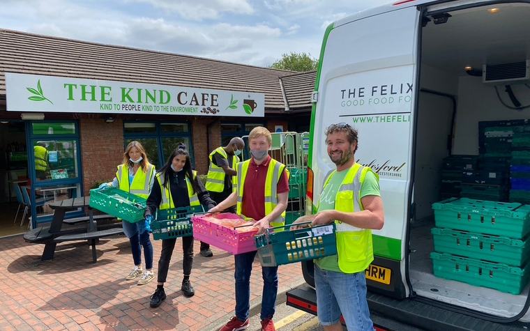 London's Community Kitchen volunteers unloading crates of surplus food from a partner van outside The Kind Cafe