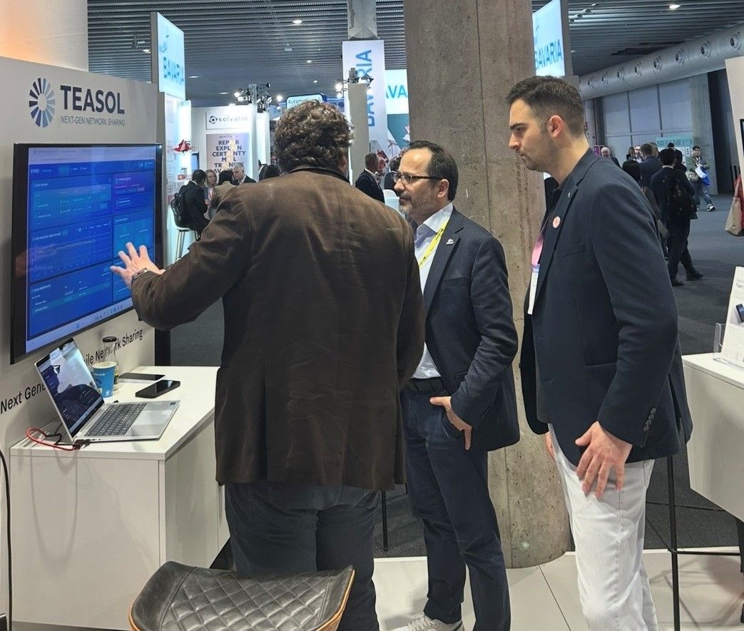 Demonstrating the TEASOL Exchange platform on a touchscreen to a visitor at MWC 2026